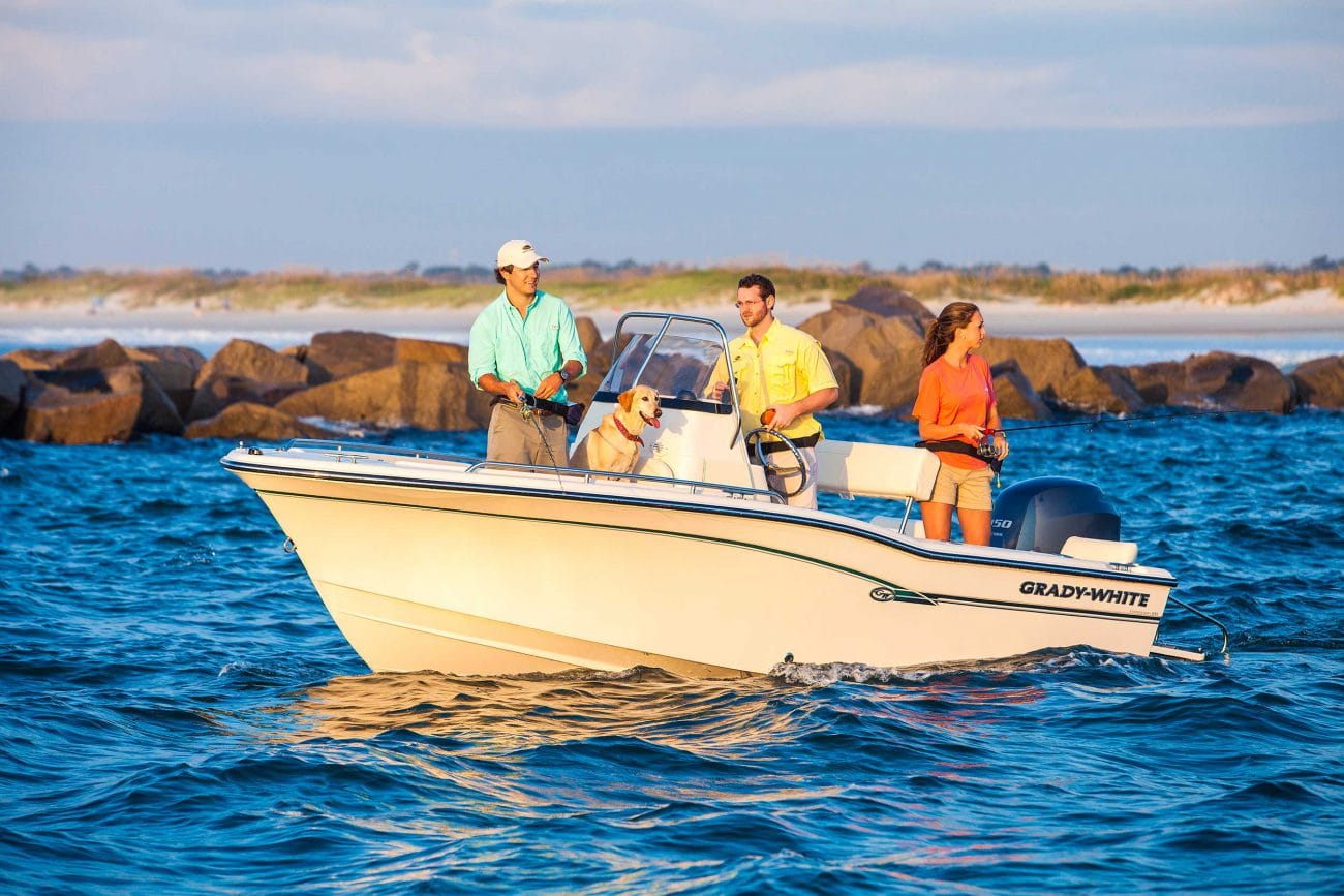 Three people and a dog on a Grady-White Fisherman 180 fishing near the shore